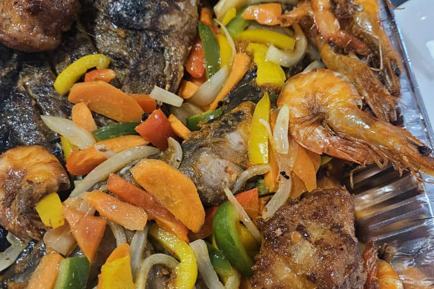 A large platter of grilled fish, prawns and peppers