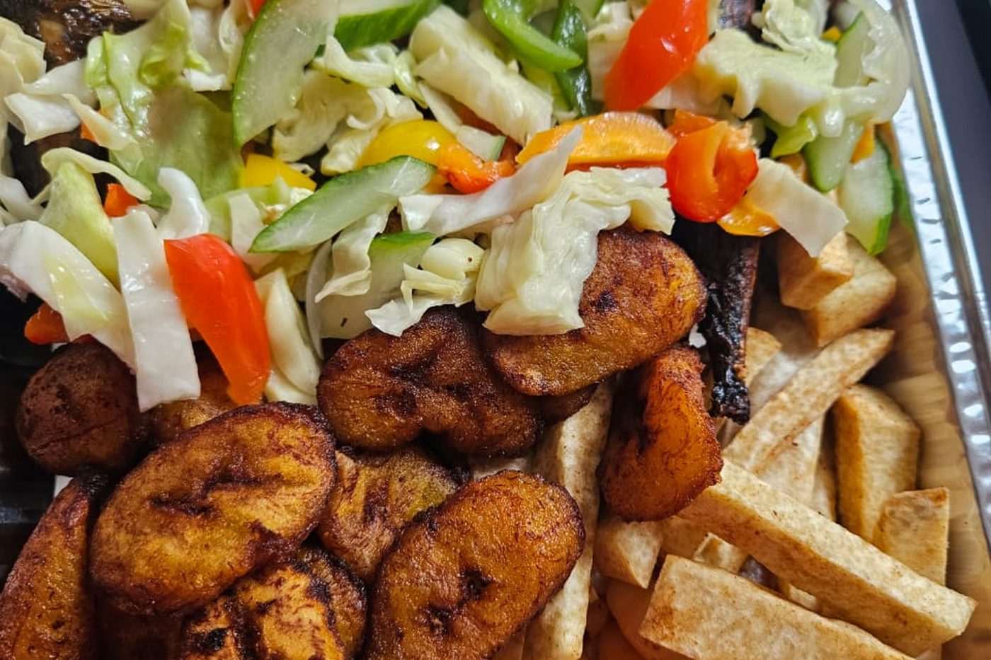 A sharing platter of fried plantain, prawns, spring rolls and coleslaw