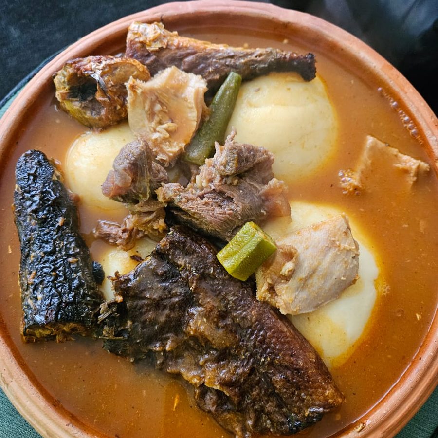 Ghanaian light soup with fish, served in an earthenware bowl