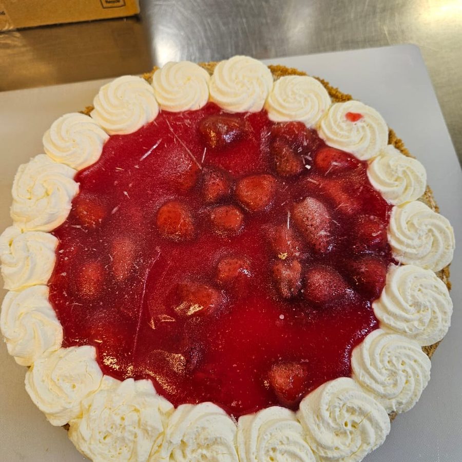 A strawberry cheesecake finished with piped cream